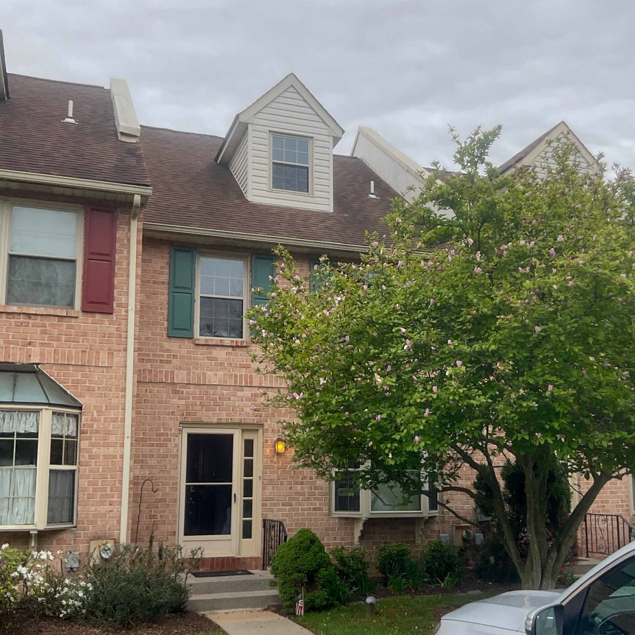 Brick townhome in Norristown, PA, an interior row unit with a gabled dormer, inspected by ValueGuard home inspectors