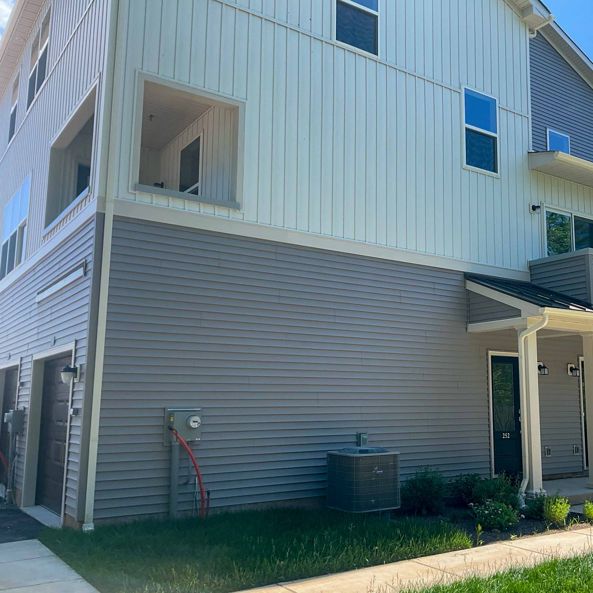 Newer vinyl-sided townhome in Norristown, PA with a ground-floor garage, inspected by a ValueGuard home inspector