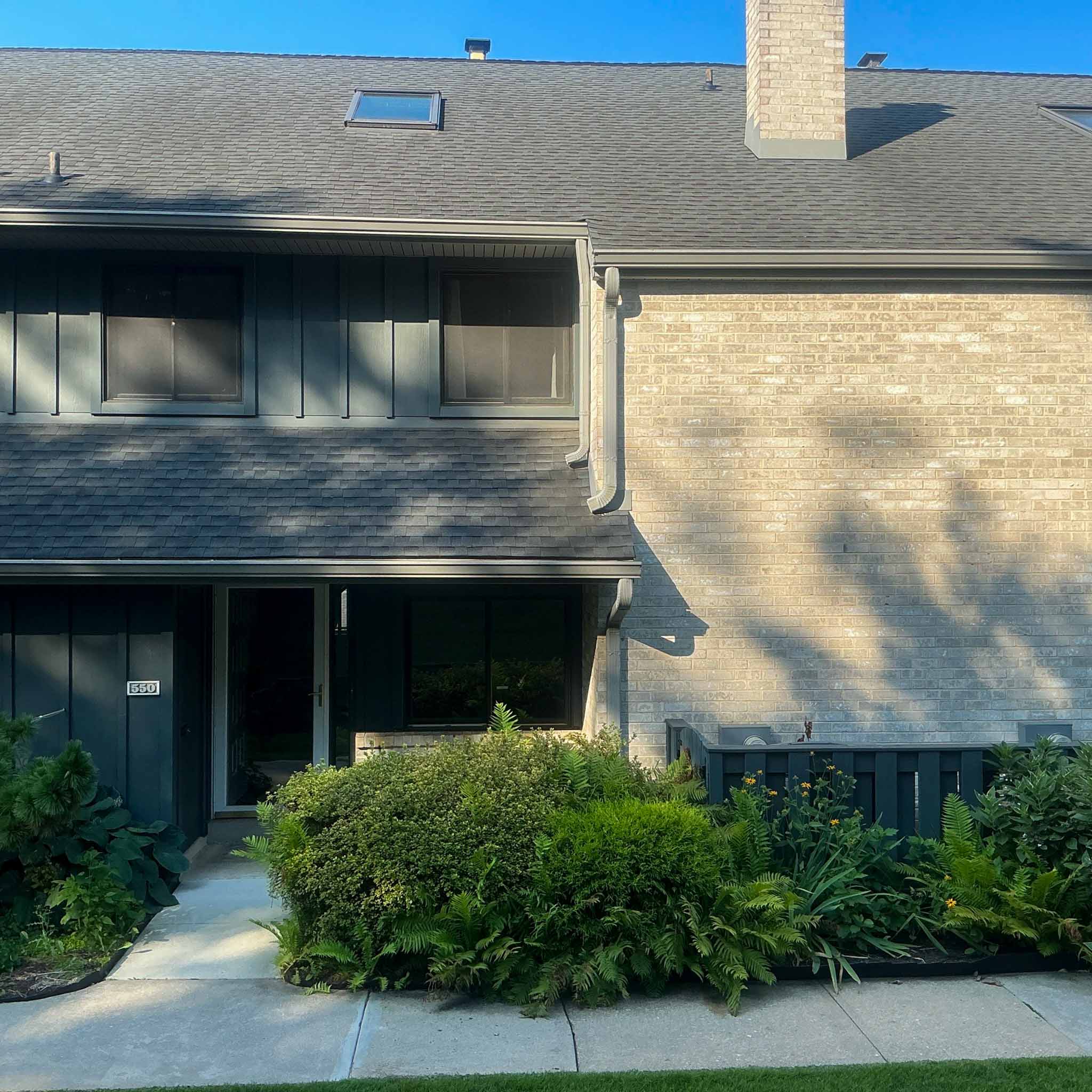 Paoli Home Inspection — Main Line Townhome Brick-and-board Main Line townhome (unit 550) with a shake-style mansard roof near the station in Paoli, Chester County PA, inspected by ValueGuard home inspectors