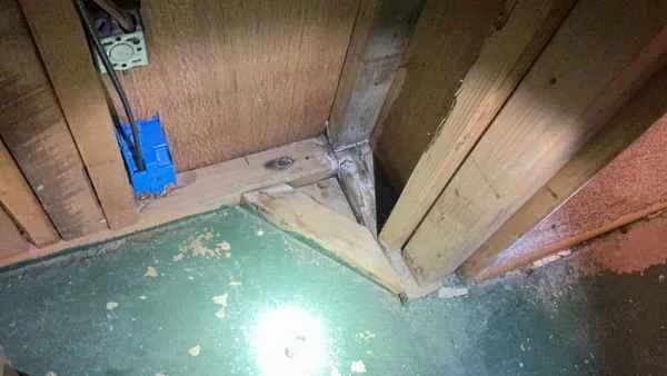 Basement moisture staining and efflorescence on foundation walls found during a post-settlement home inspection
