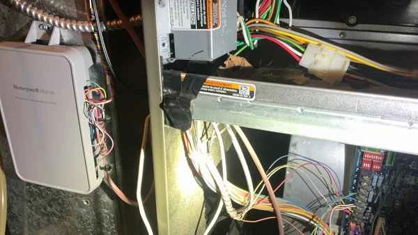Bypassed furnace blower door safety interlock switch documented during a post-settlement home inspection in Delaware County PA