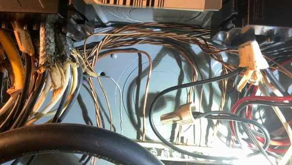 Interior of a residential sub-panel showing mixed branch circuit wiring including a solid aluminum conductor