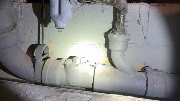 Cast iron waste piping and a sewer cleanout in questionable condition documented during a home inspection