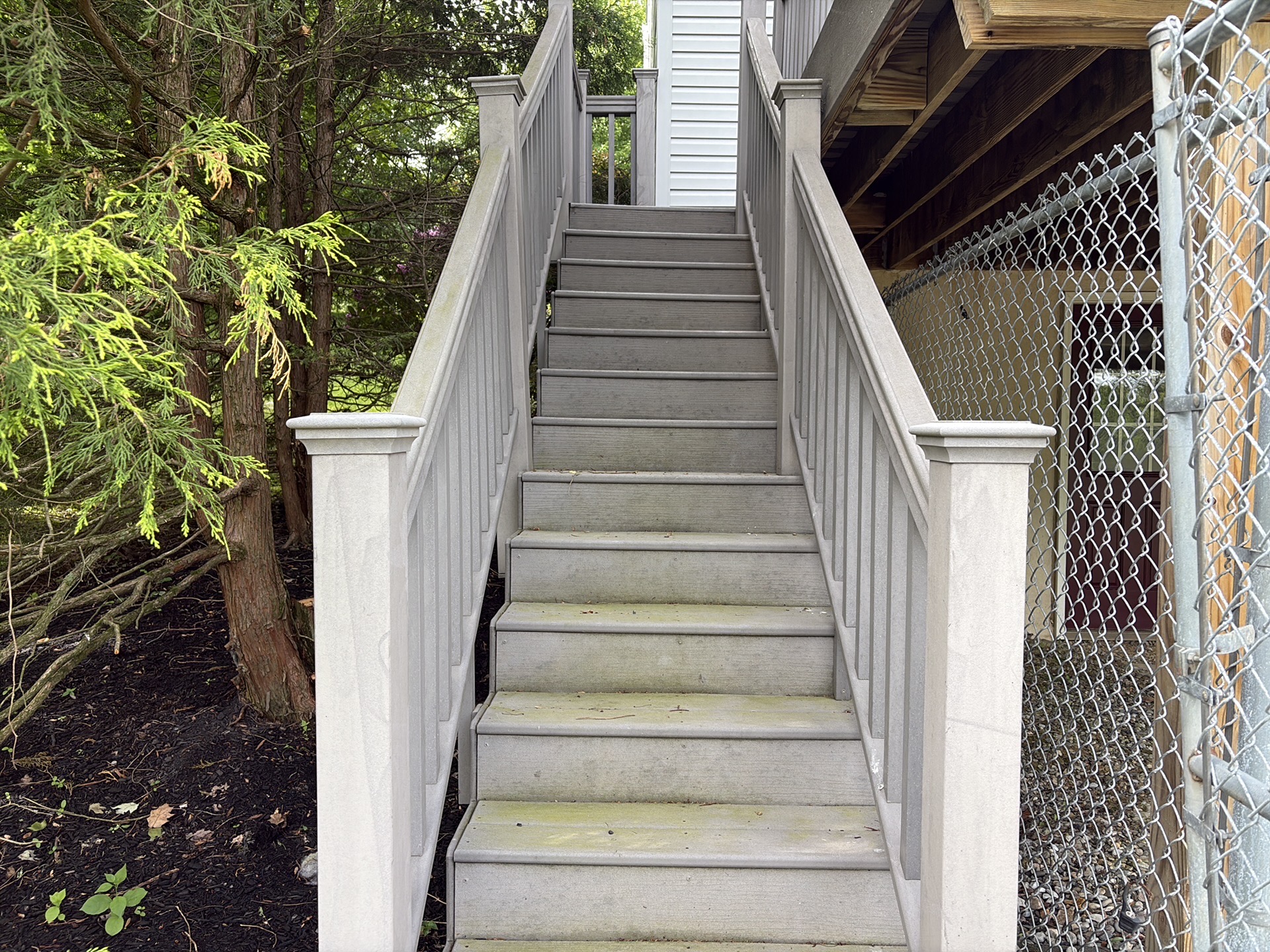 Composite deck staircase showing a slope to one side.